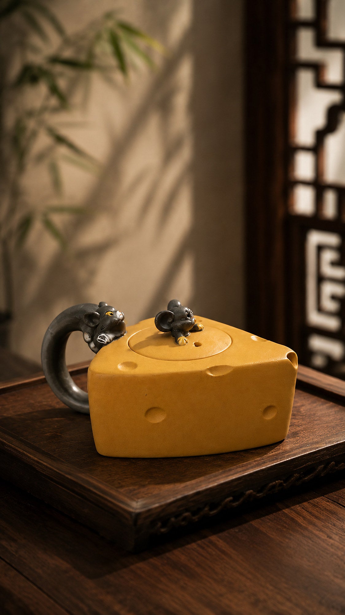 Cheese-form Yixing teapot in golden Duanni, front view on a carved wood table