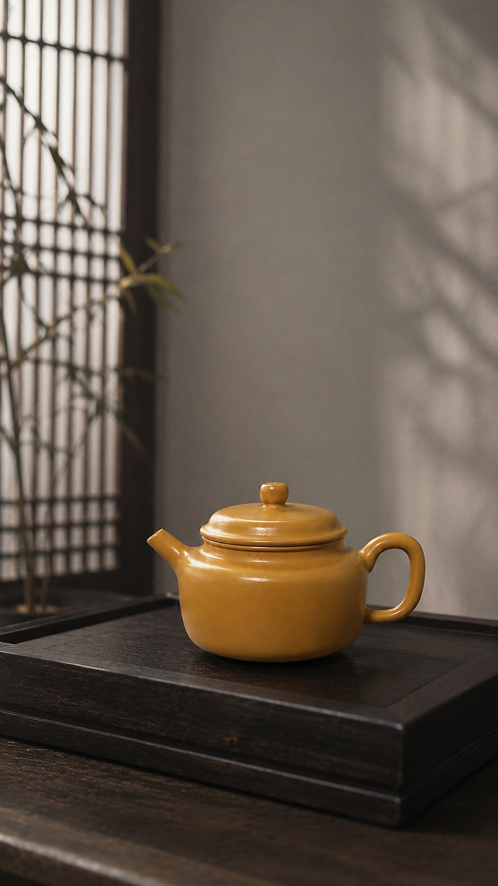 Dezhong Yixing teapot in golden Zhuni, wide profile on a dark wood platform