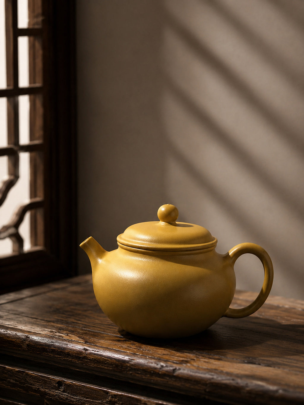 Gong Zhu Yixing teapot in golden Zhuni, left profile on a rustic tabletop