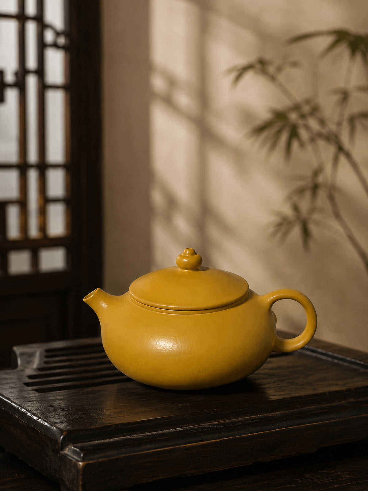 Han Jiang Yixing teapot in golden Zhuni, left profile on a tea tray beside bamboo shadows
