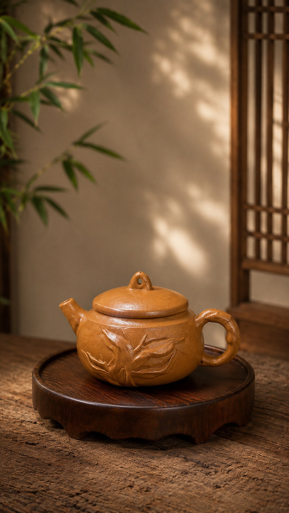 Hanwa Yixing teapot in golden Duanni, left profile on a carved stand