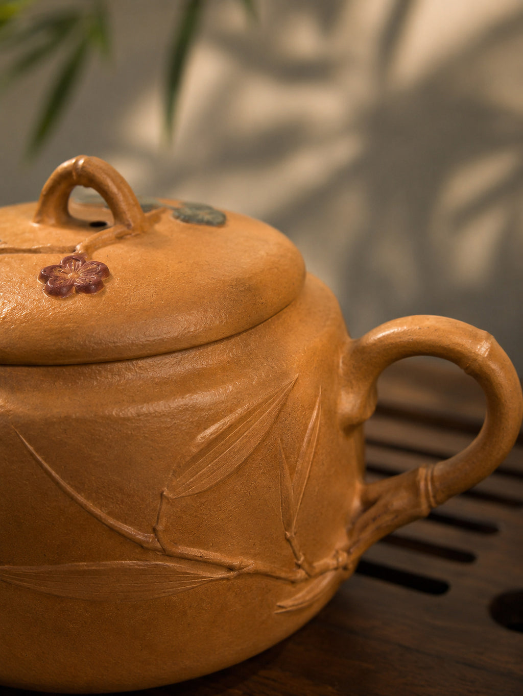 Hanwa Yixing teapot in golden Duanni, close-up of handle and incised branch relief