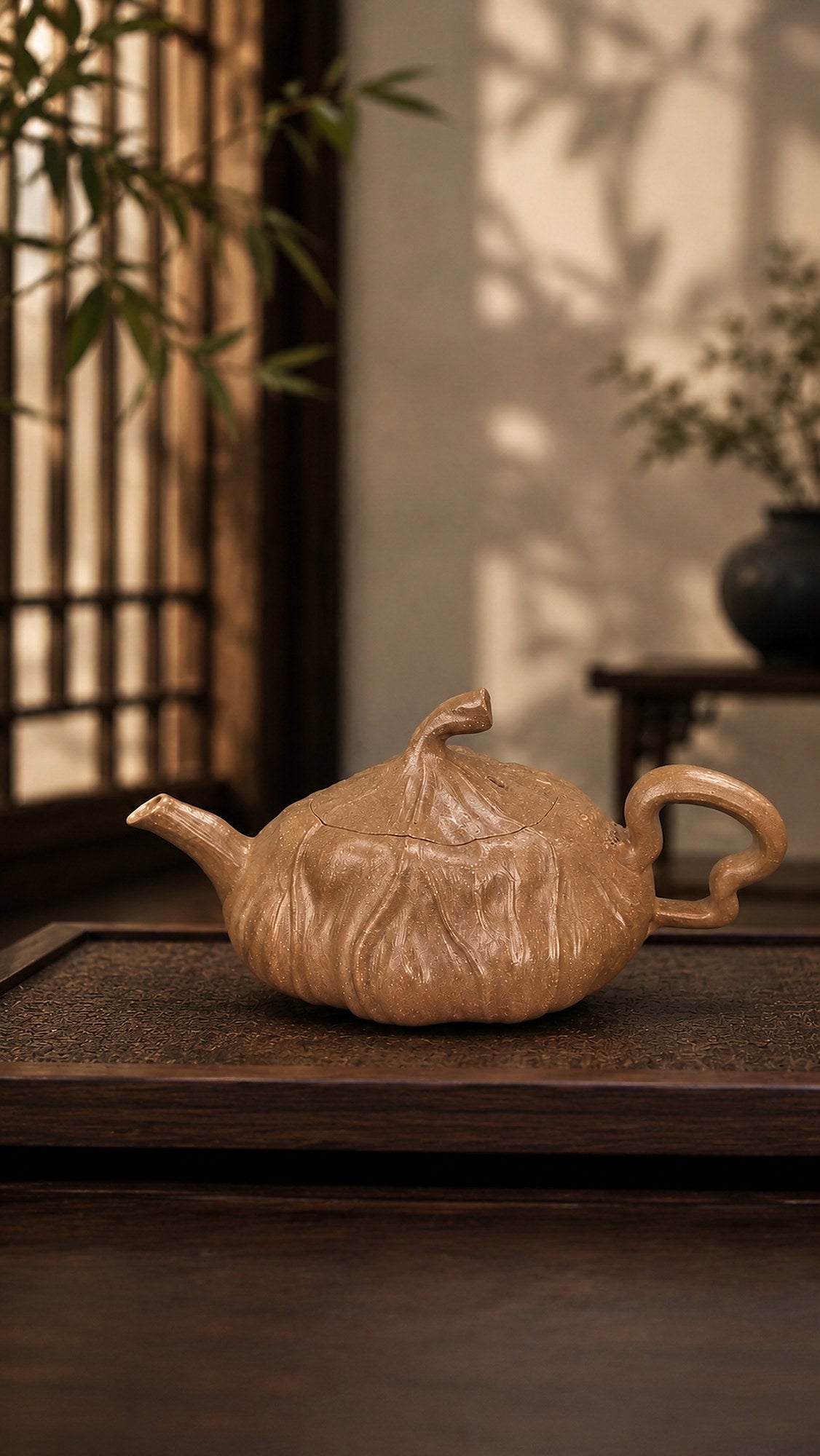 Lotus-form Yixing teapot in aged Duanni, profile view on a dark wood tabletop