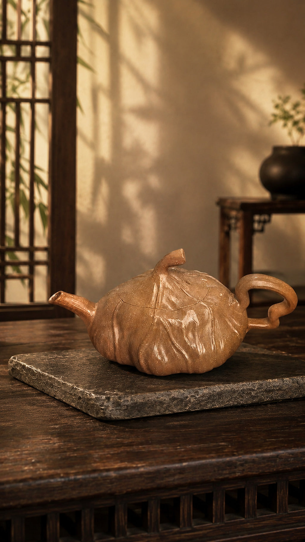 Lotus-form Yixing teapot in aged Duanni, profile on a stone slab in warm light