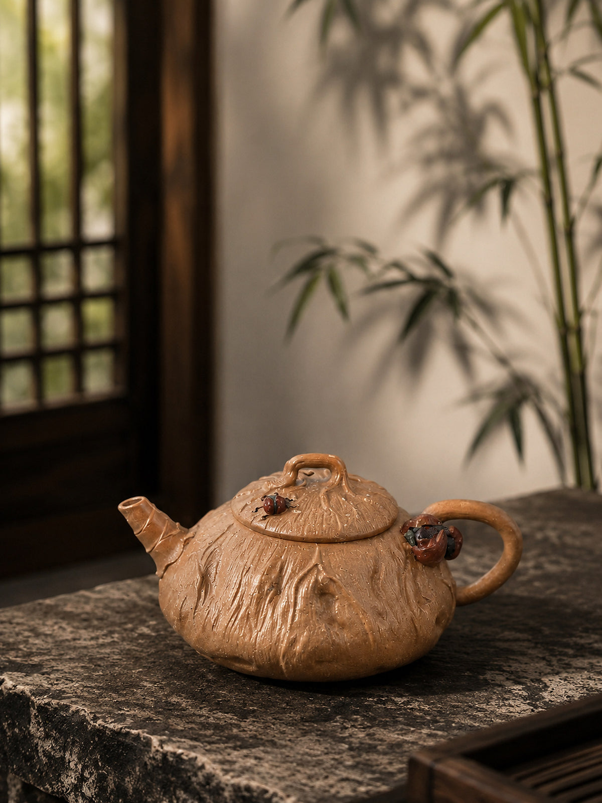 Lotus-form Yixing teapot in aged Duanni, left profile on a rough stone slab