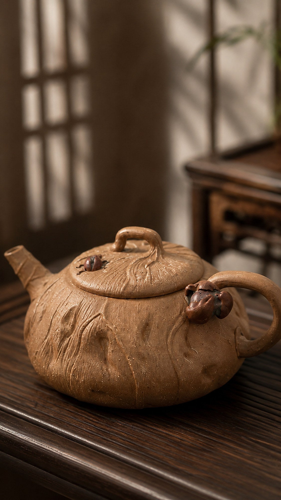 Lotus-form Yixing teapot in aged Duanni, close three-quarter view of sculpted texture