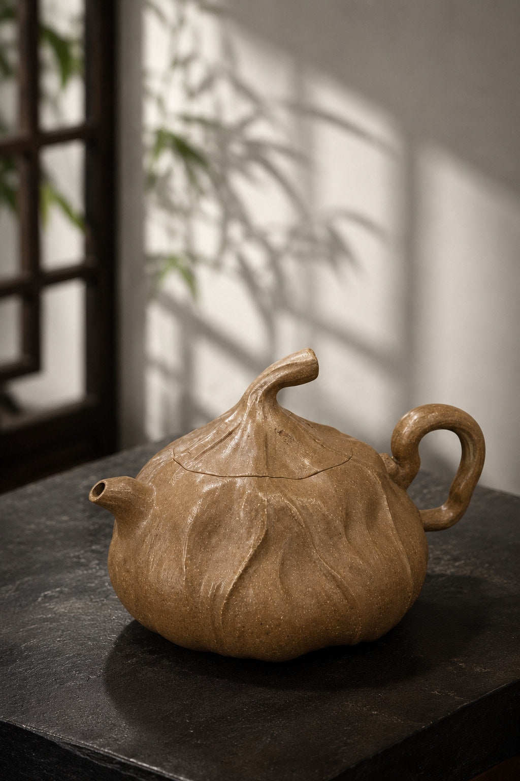 Lotus Sculptural Form teapot, full alternate side view on a dark tabletop in window light