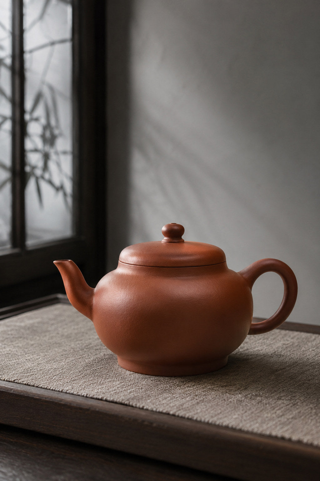 Palace Lantern teapot, full alternate side view on a pale woven mat