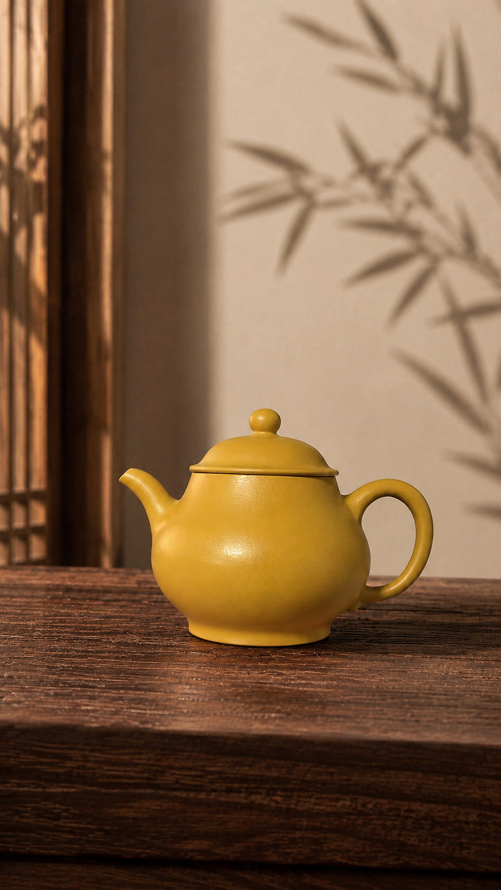 Pan Hu Yixing teapot in golden Zhuni, left profile on a wood table