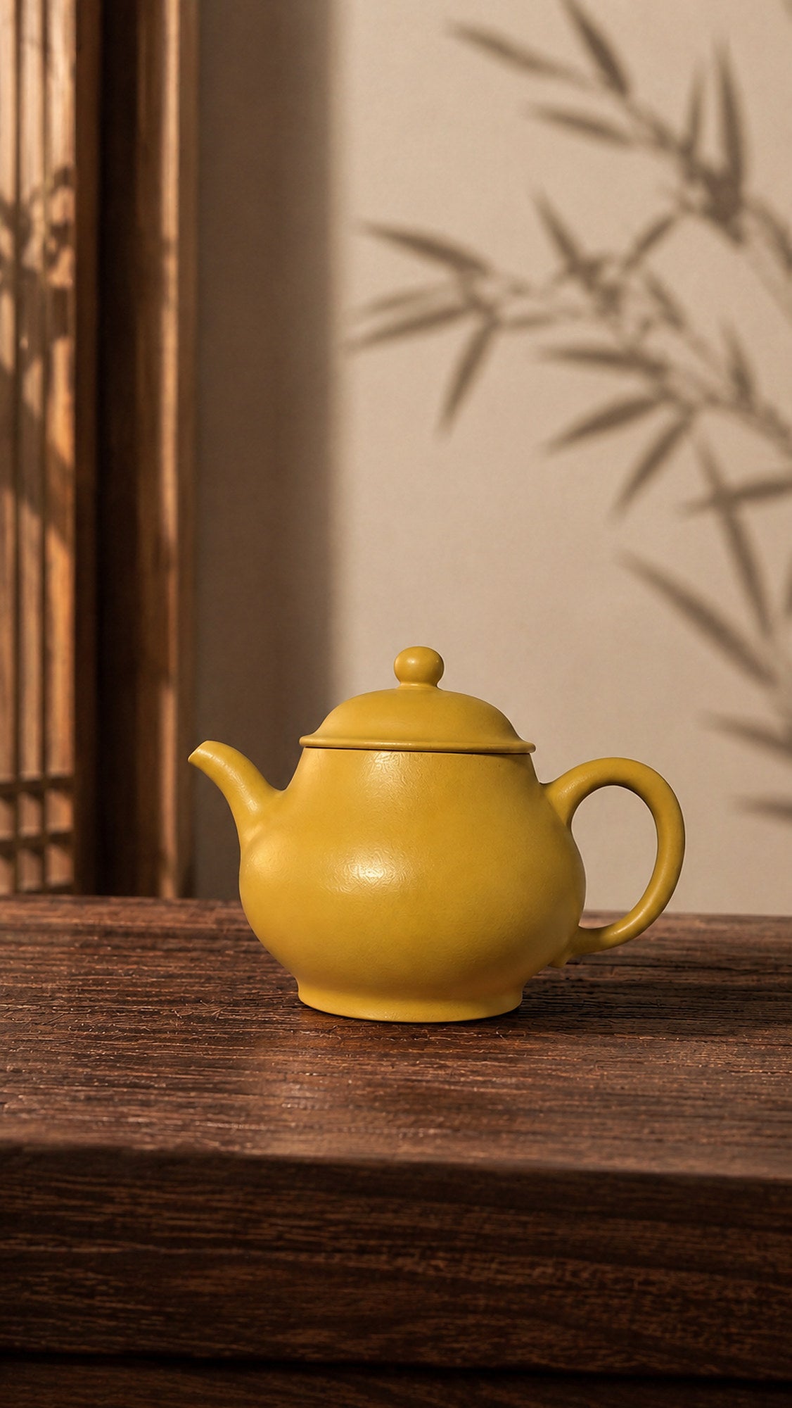 Pan Hu Yixing teapot in golden Zhuni, left profile on a wood table