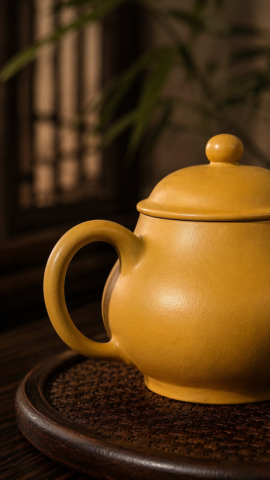 Pan Hu Yixing teapot in golden Zhuni, close-up of loop handle and rounded body