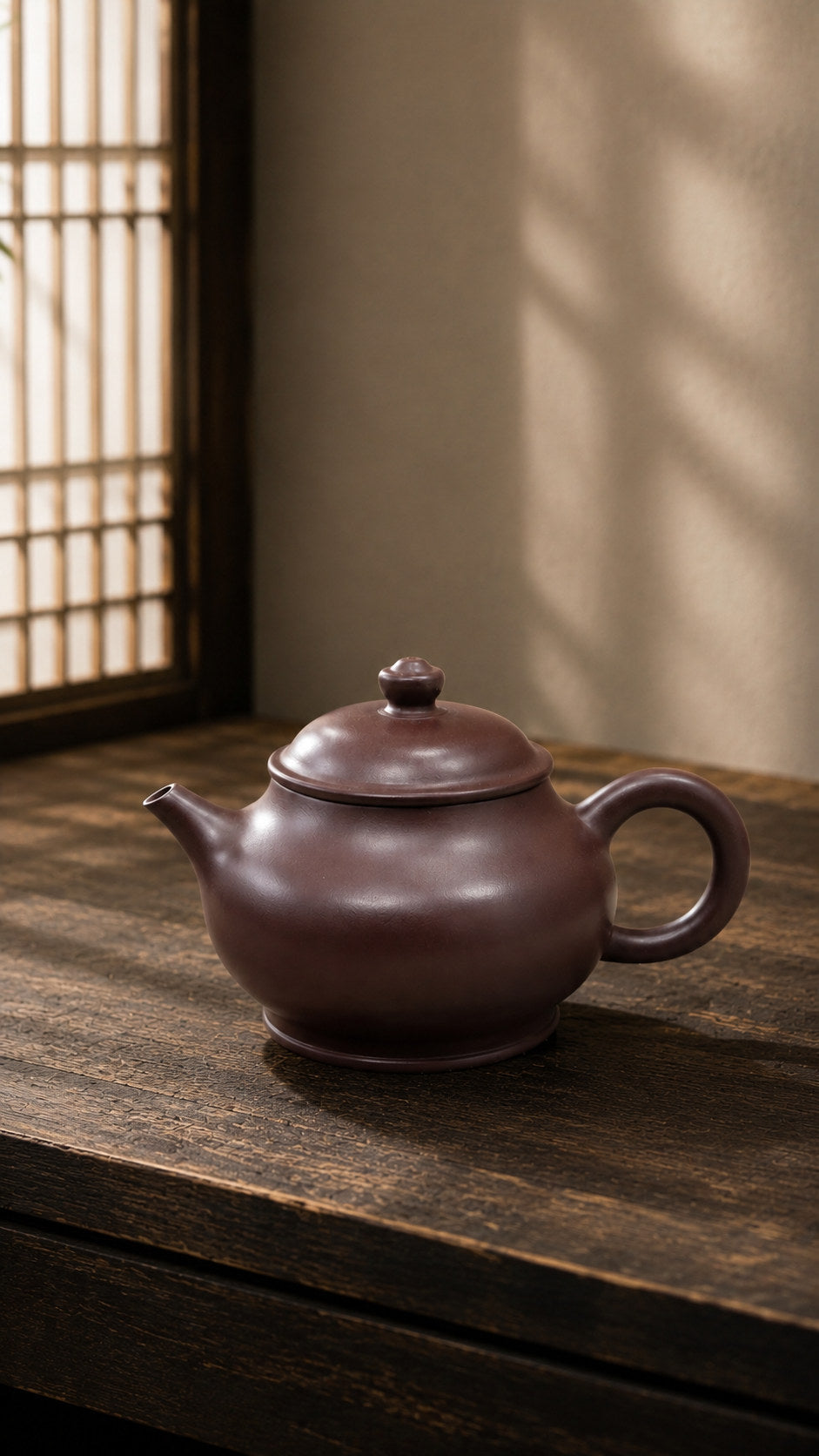 Pan Hu teapot, full three-quarter view on a wooden table in window light