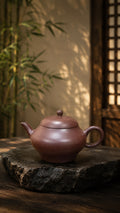Longxuesha pear-shaped Yixing teapot, full side view on stone
