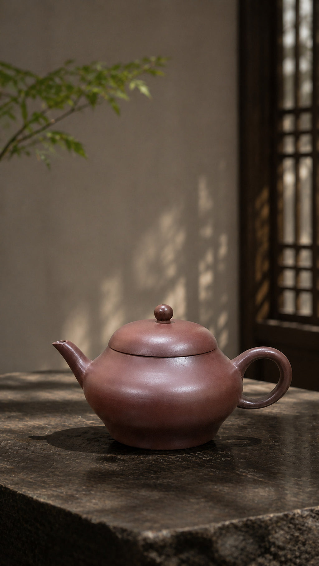 Longxuesha pear-shaped teapot displayed on gray stone