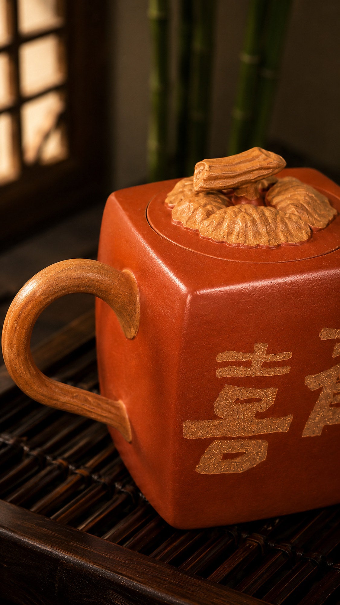 Persimmon-square Yixing teapot in aged Duanni, close-up of loop handle and character decoration