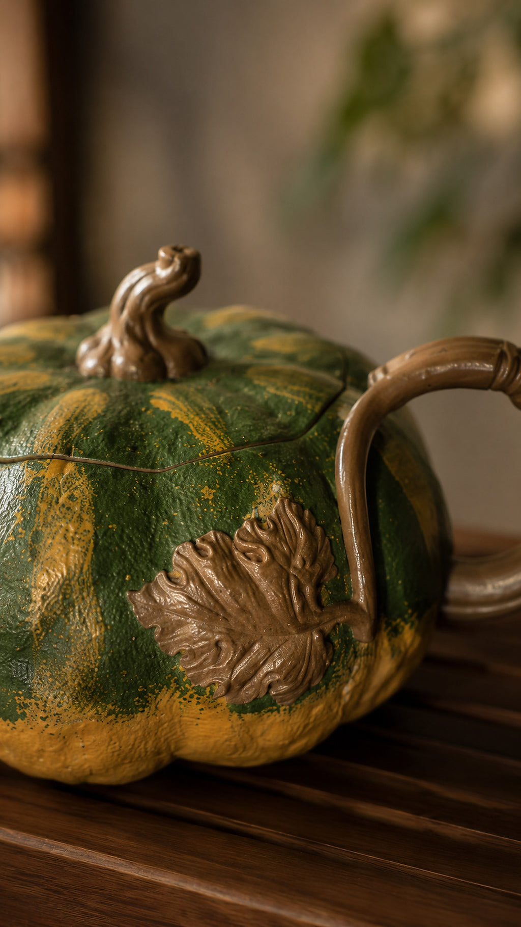 Pumpkin-form Yixing teapot in aged Duanni, close-up of handle and leaf relief