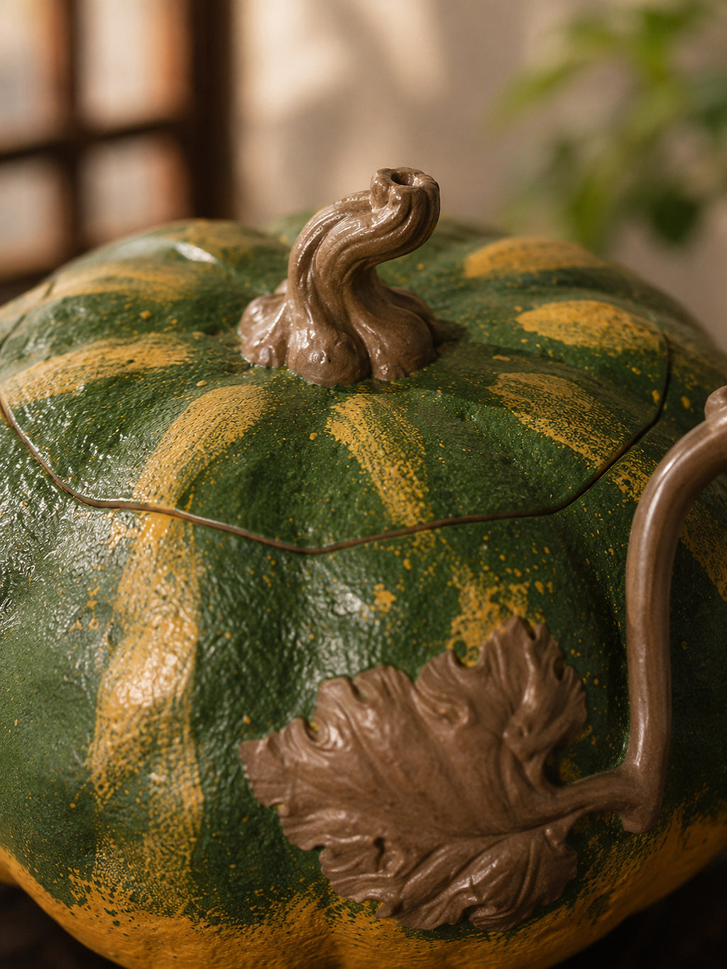 Pumpkin-form Yixing teapot in aged Duanni, close-up of sculpted stem lid and leaf relief