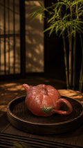 Pumpkin-form Yixing teapot in Jiangponi, top three-quarter view on a round tray