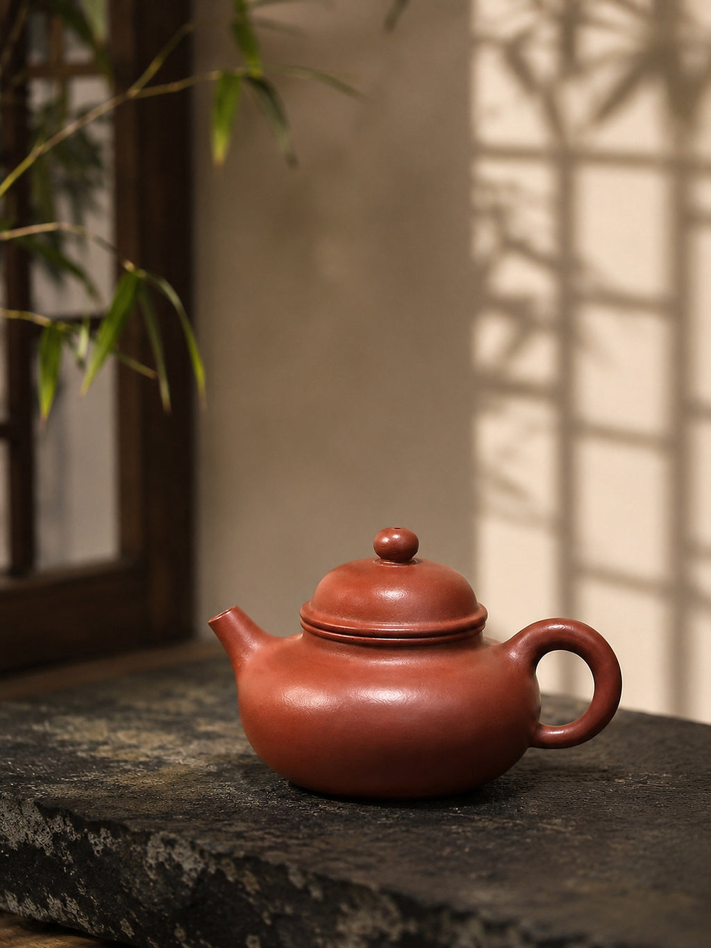 Zhuni clay Rongtian teapot, side profile on dark stone