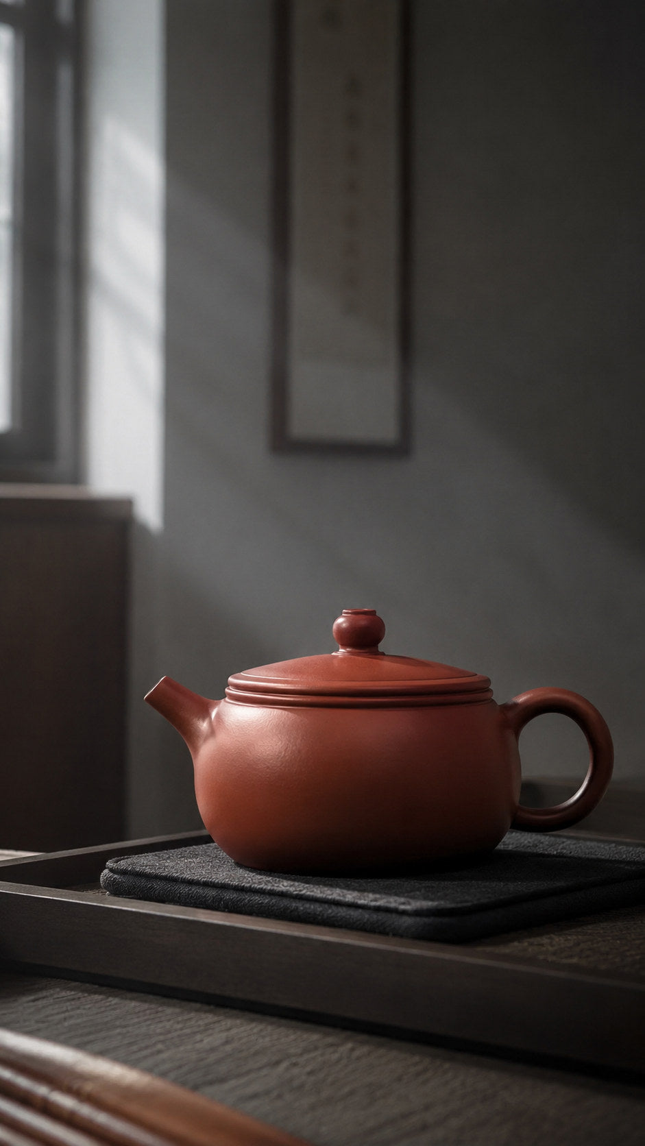 Shi Gu teapot, wide alternate side view in a shaded tea room