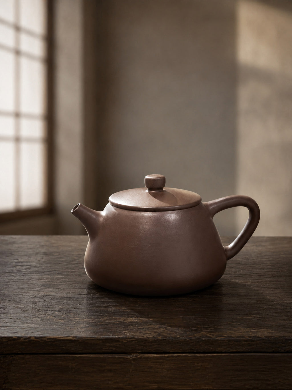 Flat-Lid Shipiao teapot, full alternate side view on a dark table in soft window light