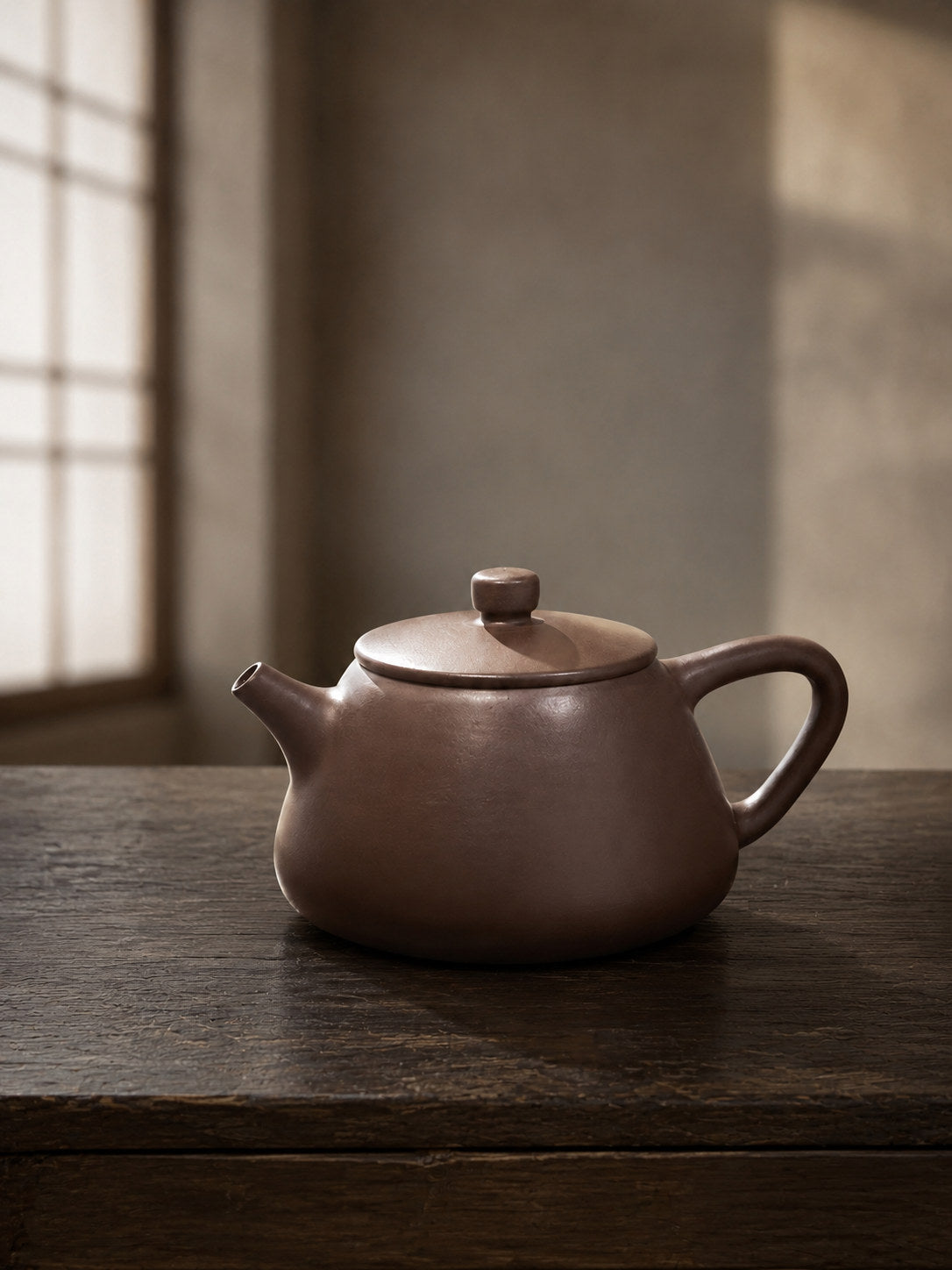 Flat-Lid Shipiao teapot, full alternate side view on a dark table in soft window light