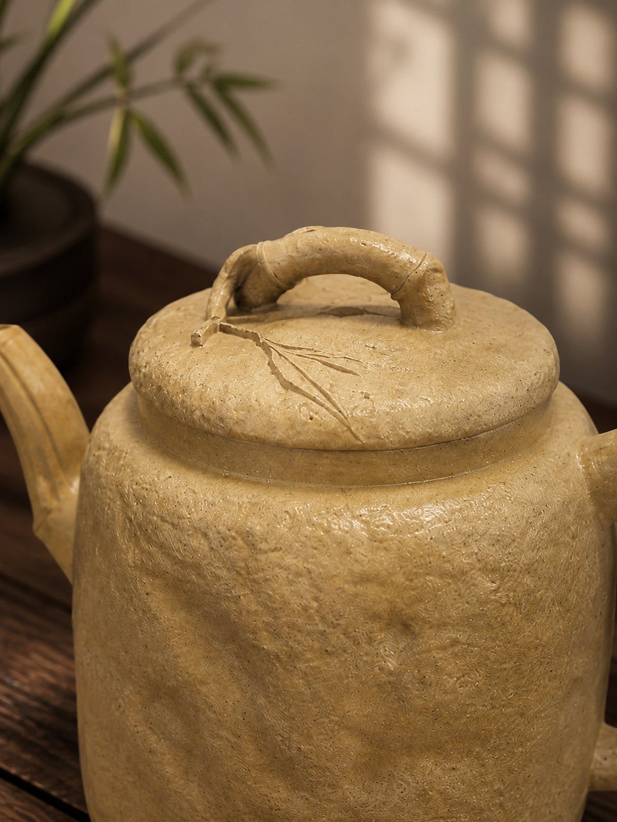 Square Form Yixing teapot in aged Duanni, close-up of lid handle and incised branch