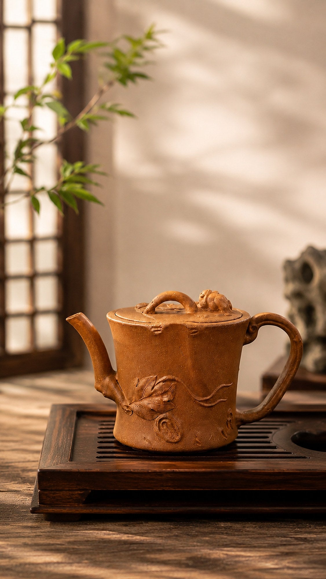 Tree-trunk-form Yixing teapot in yellow Jiangponi, left profile on a tea tray