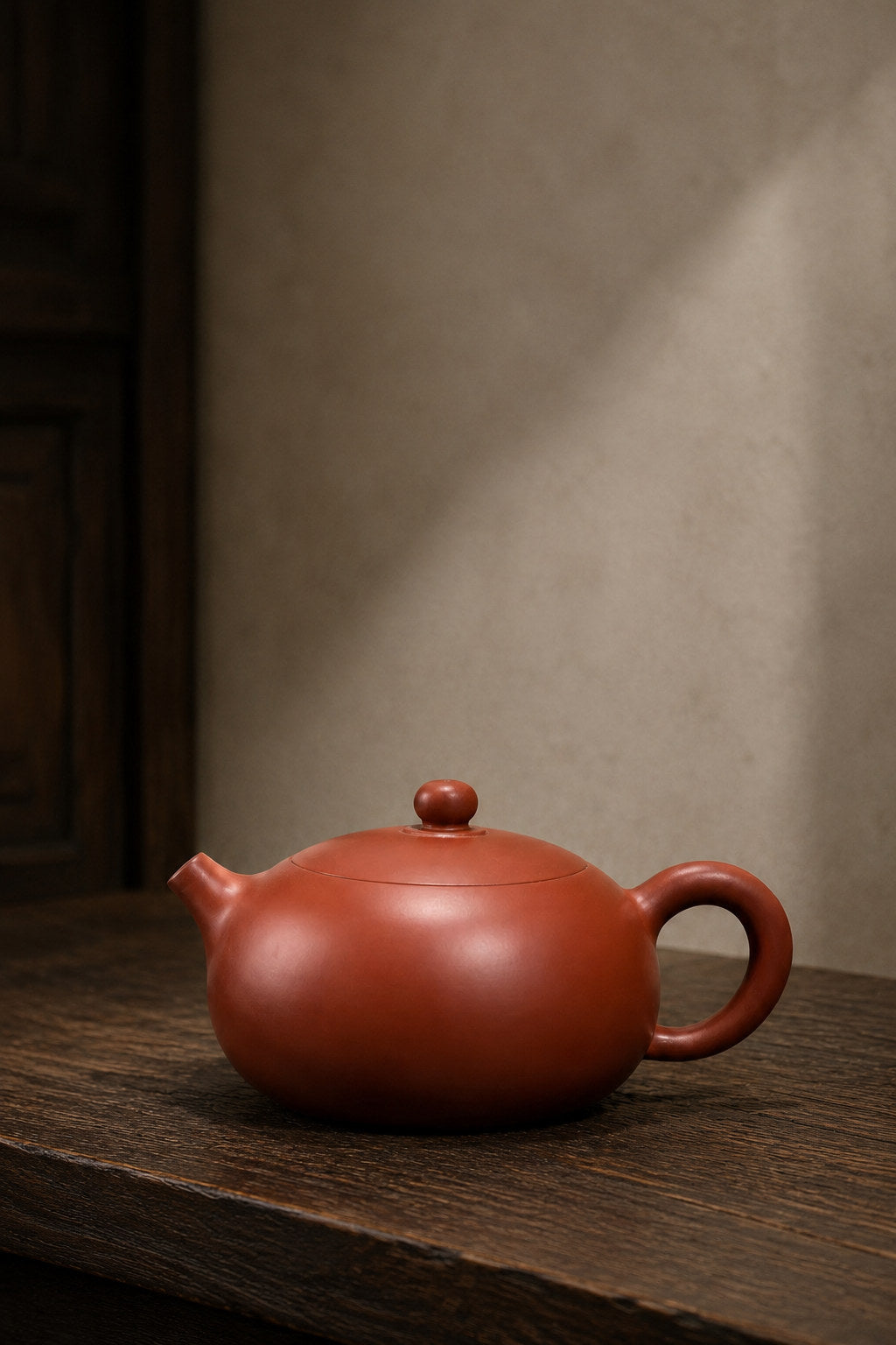 Xishi teapot, full alternate side view in a softly lit room