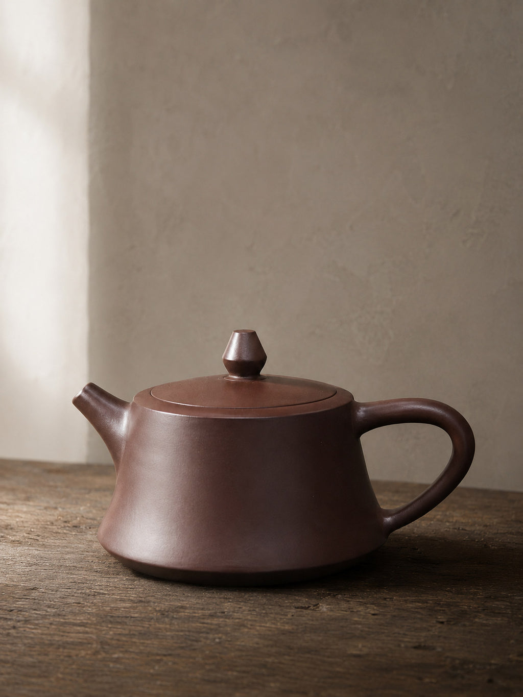 Zhu Chu teapot, full alternate side view on a rustic tabletop
