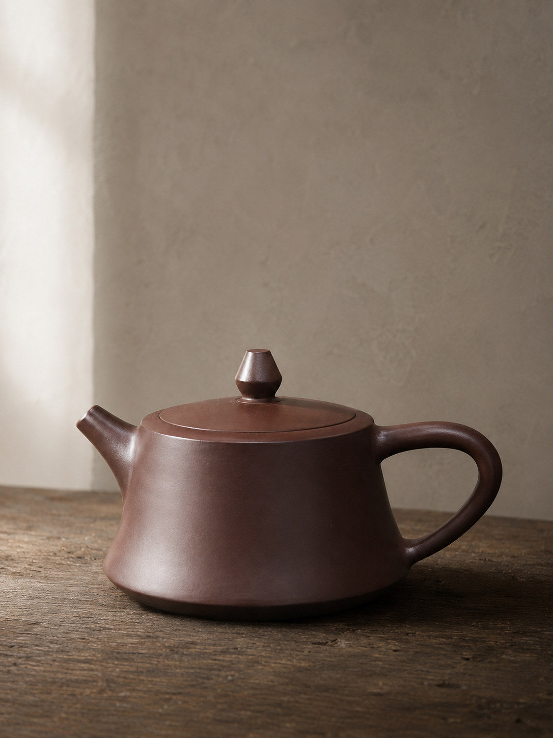 Zhu Chu teapot, full alternate side view on a rustic tabletop